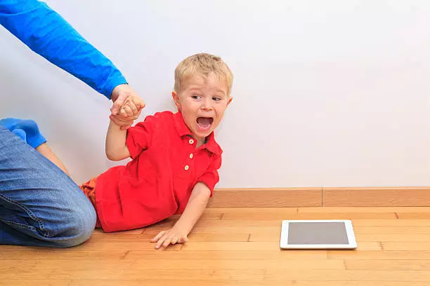 Image of a boy addicted to his tablet